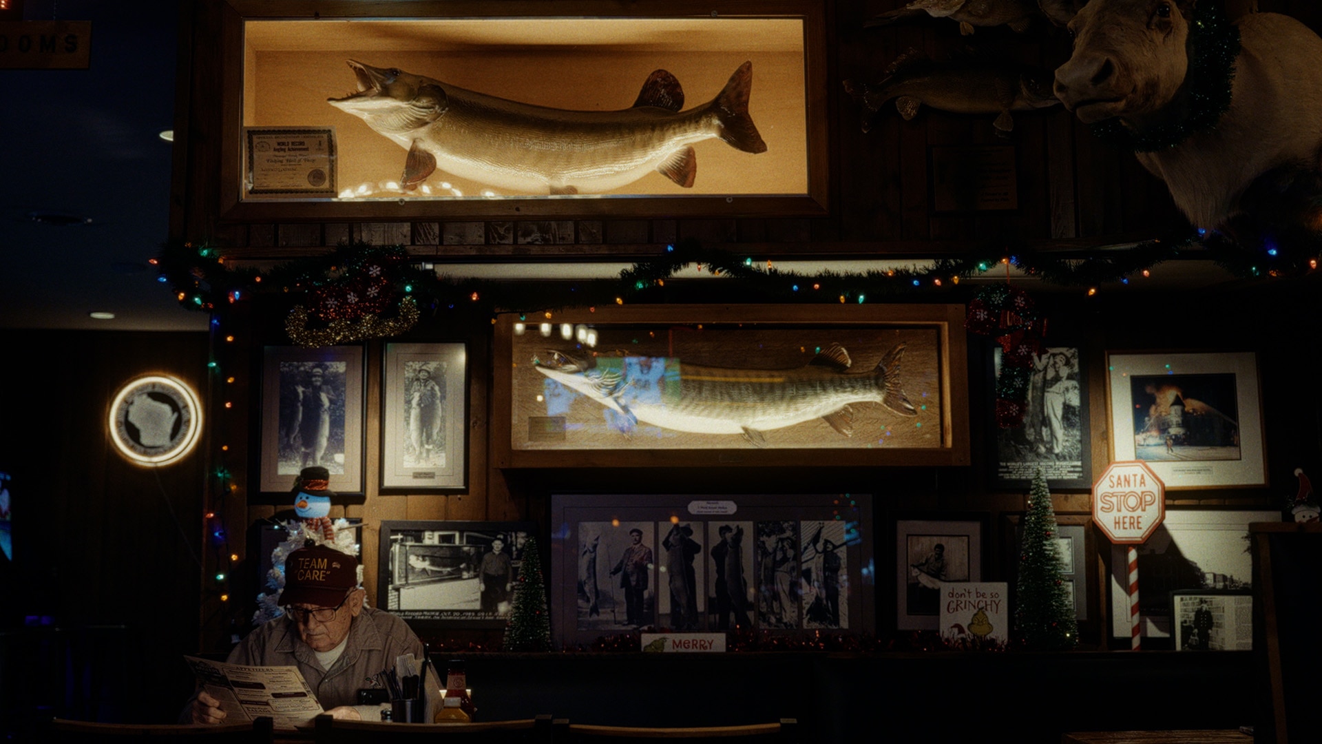 Ramsell aka “MuskieMan” in front of all his trophies and frames